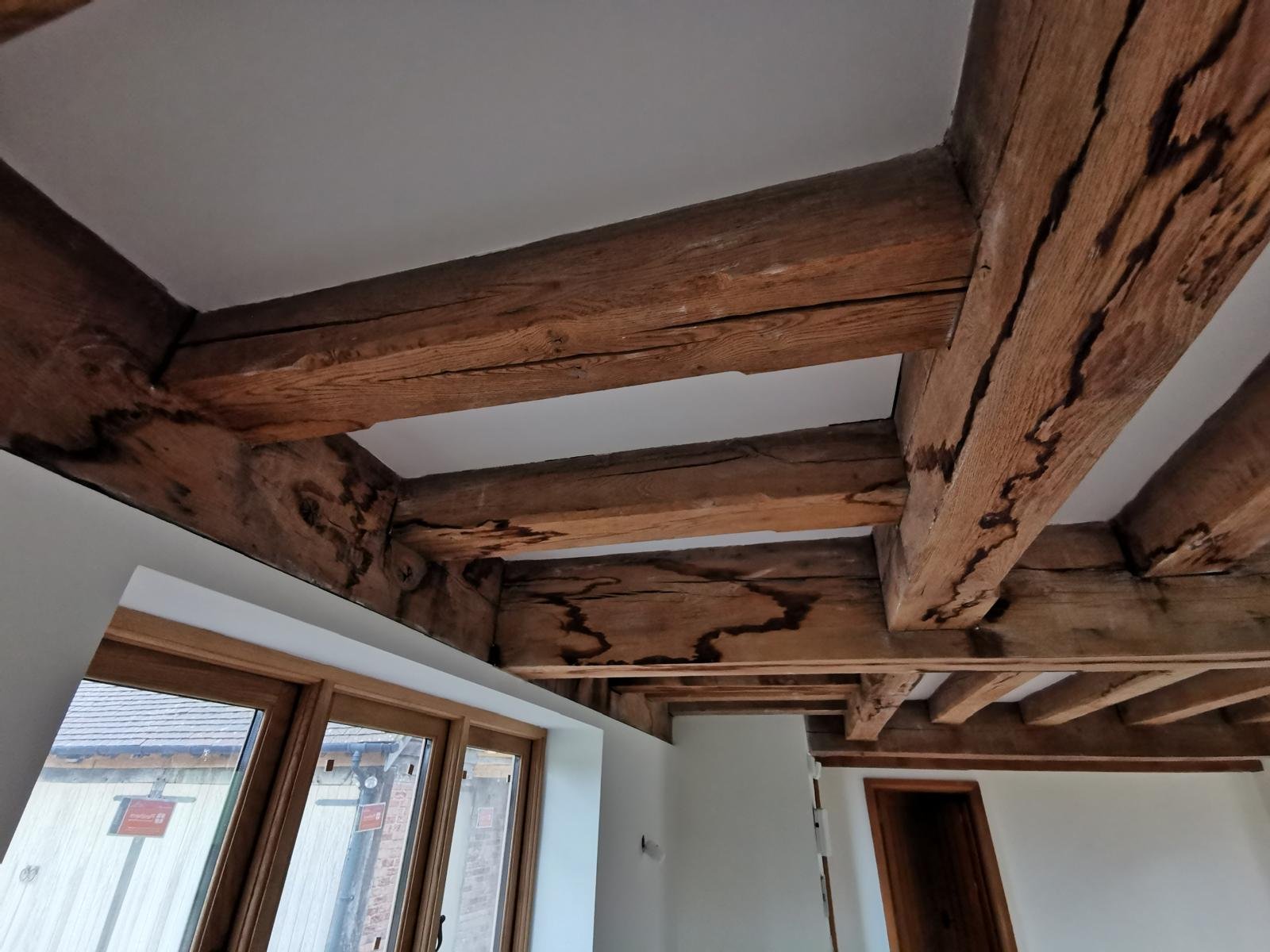 Water-damaged oak beams before restoration